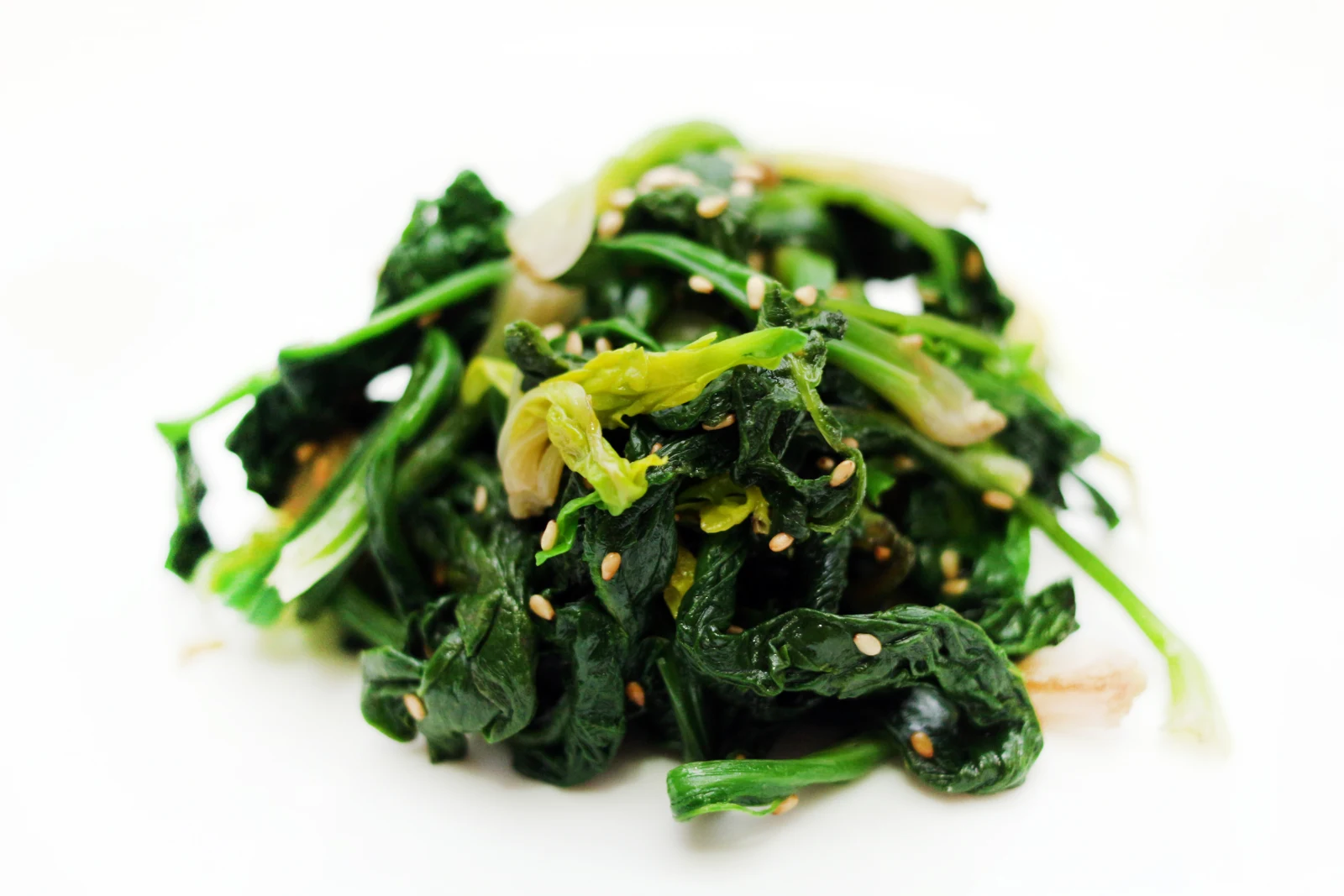 Spinach leaves and stems with sesame seeds