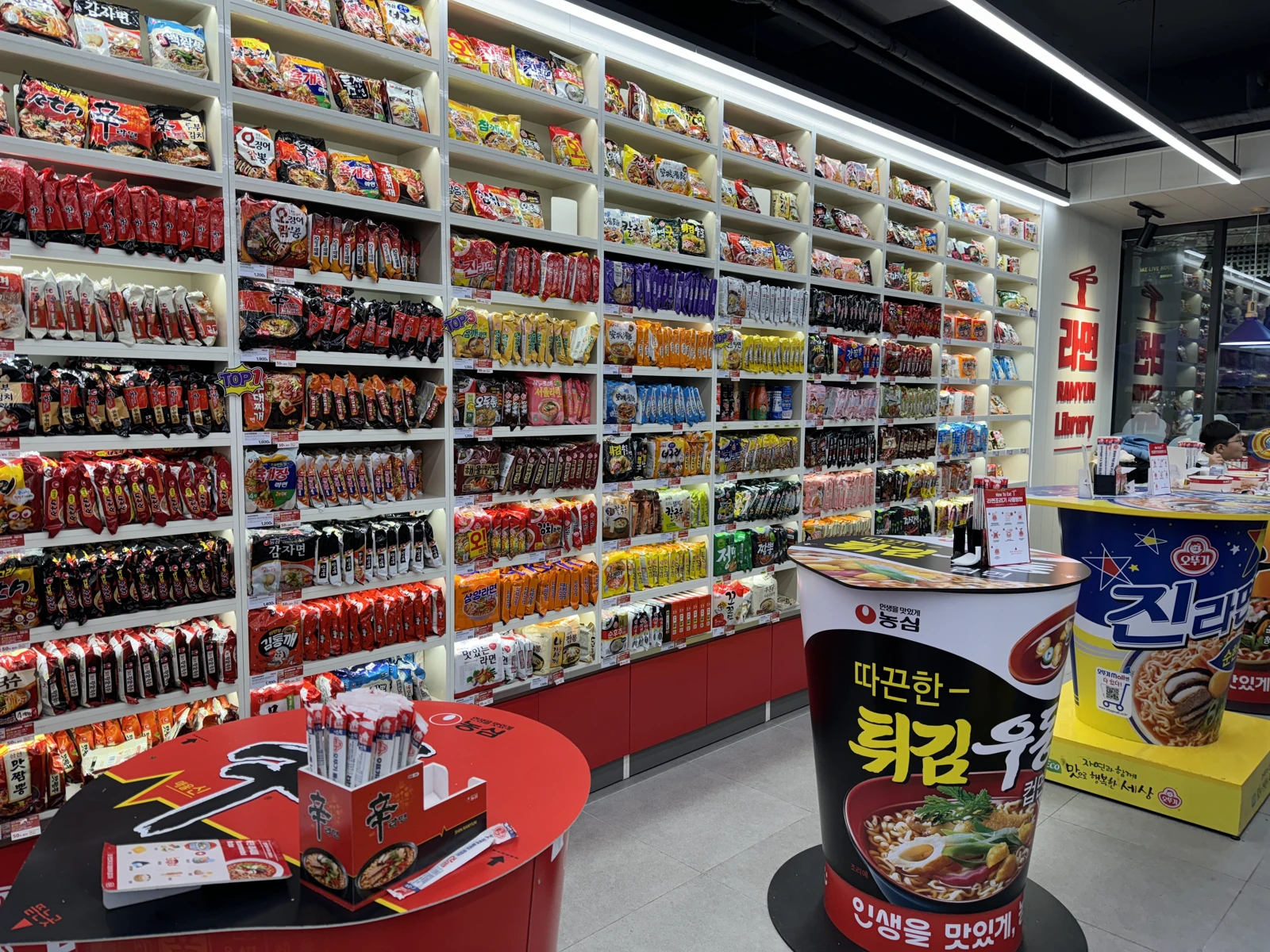 Noodle displays and cylindrical tables in Hongdae