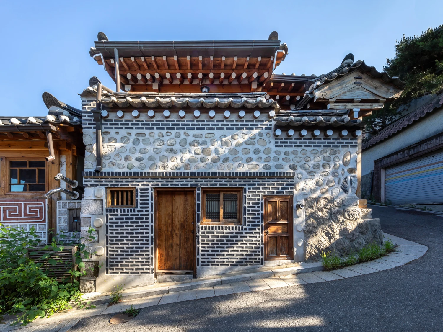 Sloping Bukchon street and wooden hanok door