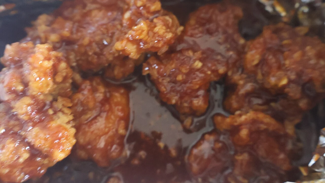 Red gloss covering uneven fried chicken coating