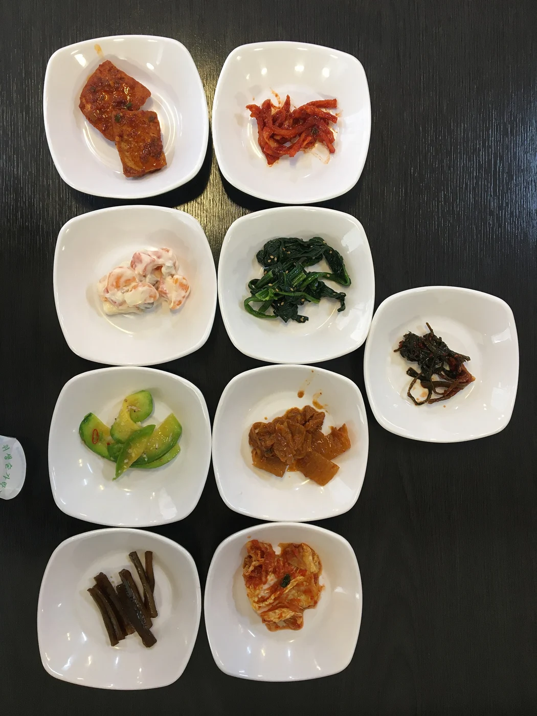 Several plates holding small portions of side dishes