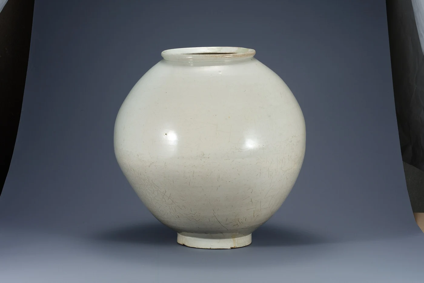 White porcelain moon jar with a short neck and a rounded body