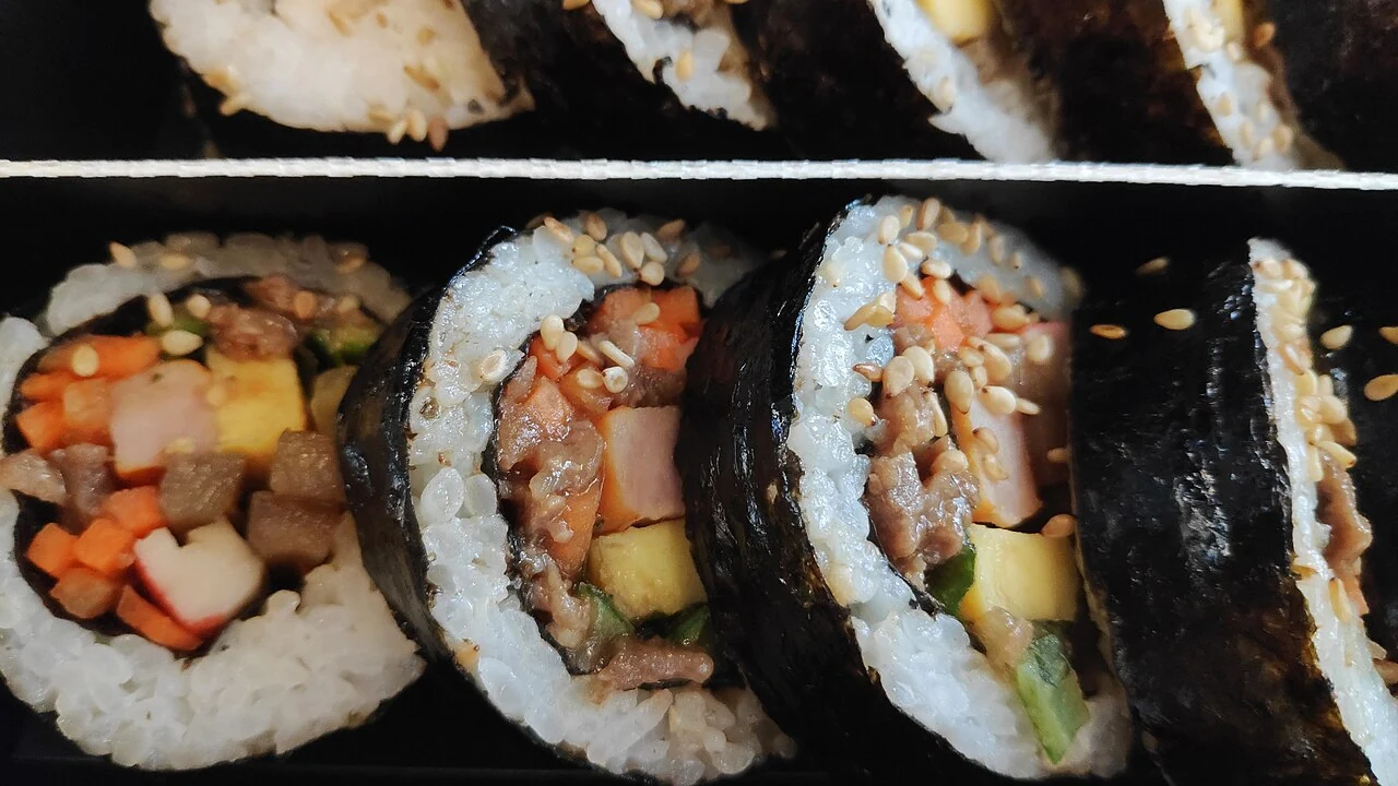 Close view of gimbap slices in a divided box