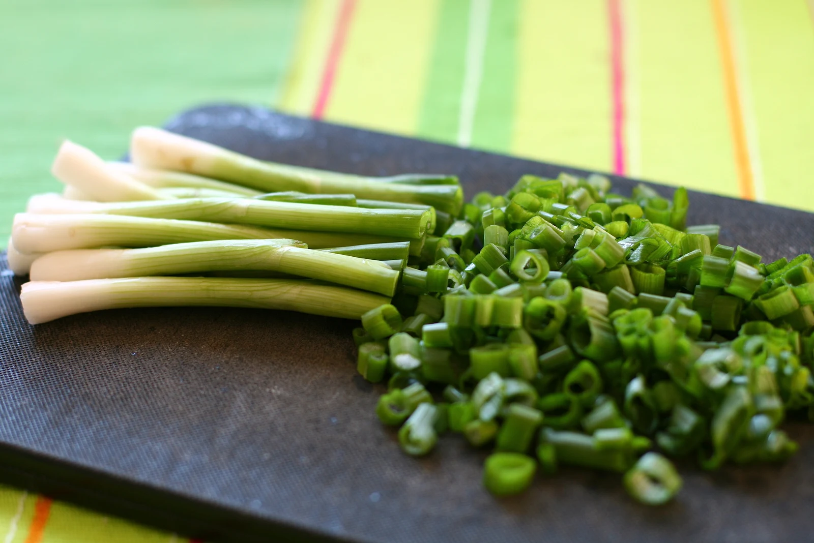 Spring-onion stems and sliced green sections on a cutting board. Ingredient preparation photographed by Katrin Gilger on 6 March 2010.